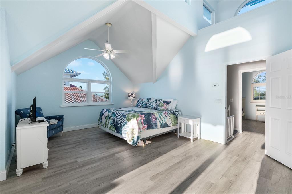 8798 Grand Avenue Boca Grande, FL 33921 - Photo 23 of 64 a bedroom with a bed wooden floor and window