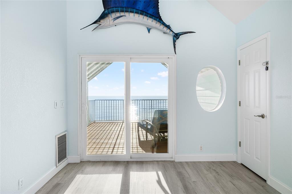 8798 Grand Avenue Boca Grande, FL 33921 - Photo 24 of 64 an empty room with wooden floor and windows
