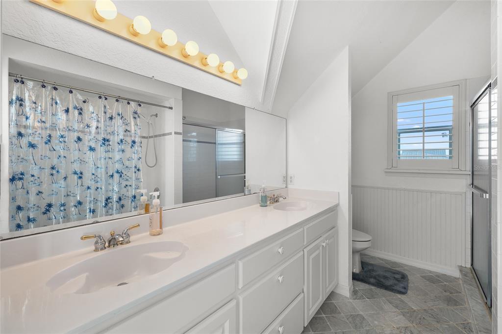8798 Grand Avenue Boca Grande, FL 33921 - Photo 35 of 64 a bathroom with a granite countertop sink and a mirror