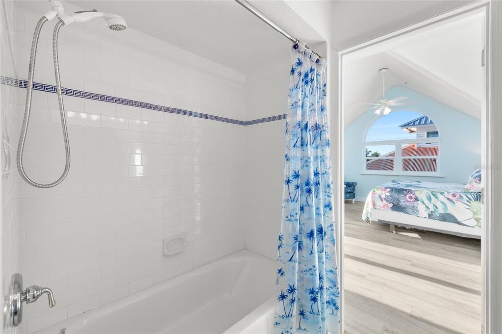 8798 Grand Avenue Boca Grande, FL 33921 - Photo 37 of 64 a bathroom with a shower curtain and a shower