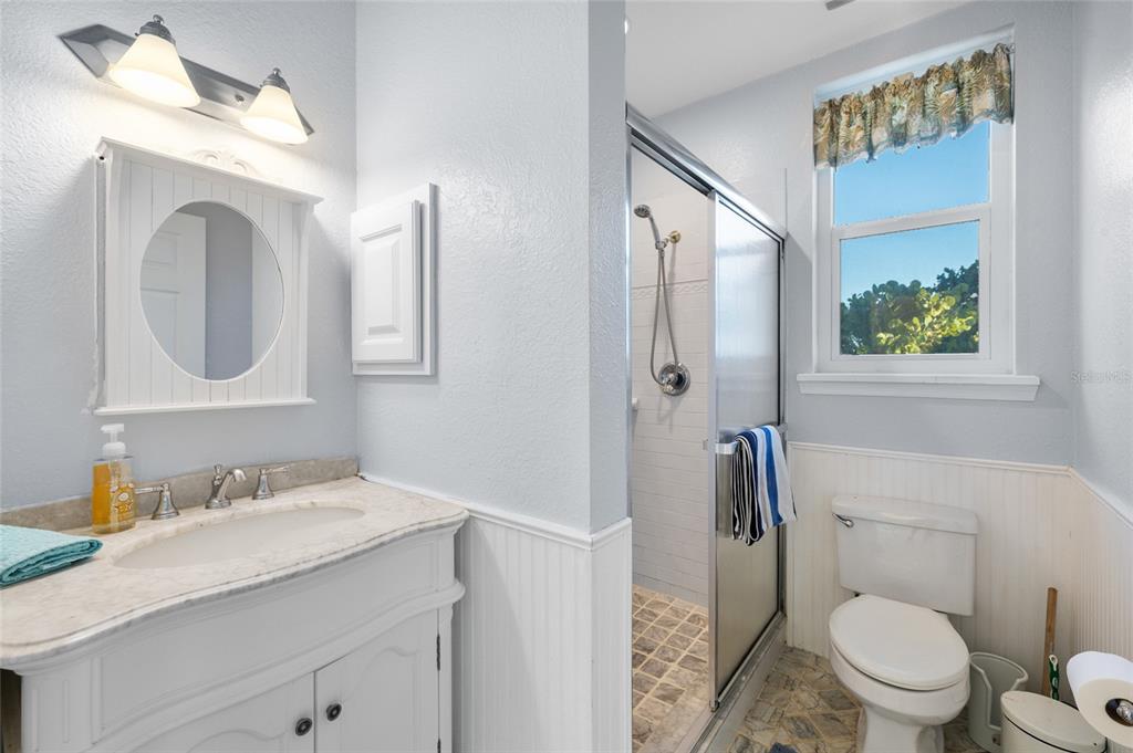 8798 Grand Avenue Boca Grande, FL 33921 - Photo 40 of 64 a bathroom with a granite countertop toilet sink and mirror