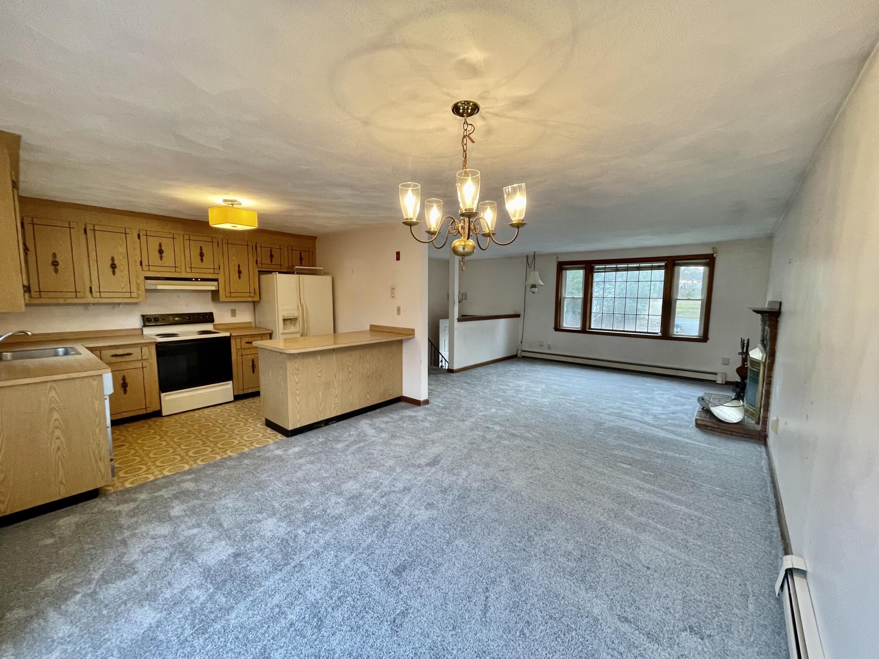 103 Clay Pond Road Bourne, MA 02532 - Photo 4 of 26 a living room with furniture and a chandelier
