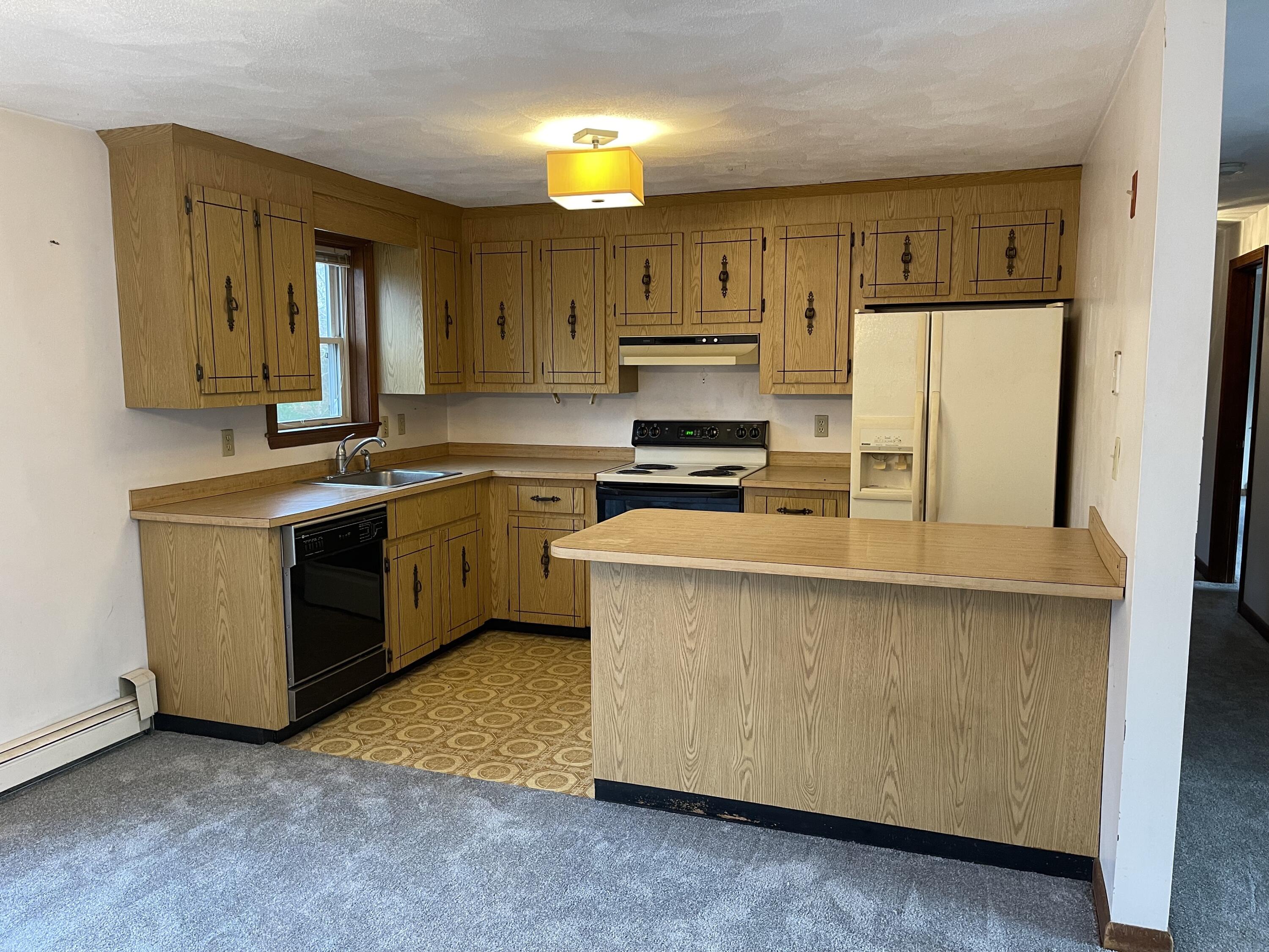 103 Clay Pond Road Bourne, MA 02532 - Photo 5 of 26 a kitchen with stainless steel appliances a stove a sink a refrigerator a window