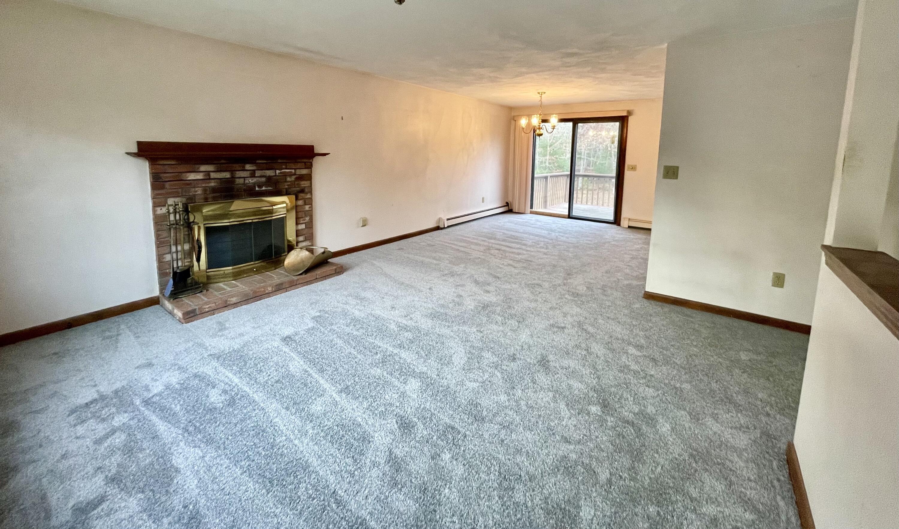 103 Clay Pond Road Bourne, MA 02532 - Photo 6 of 26 a view of an empty room with a fireplace and a window