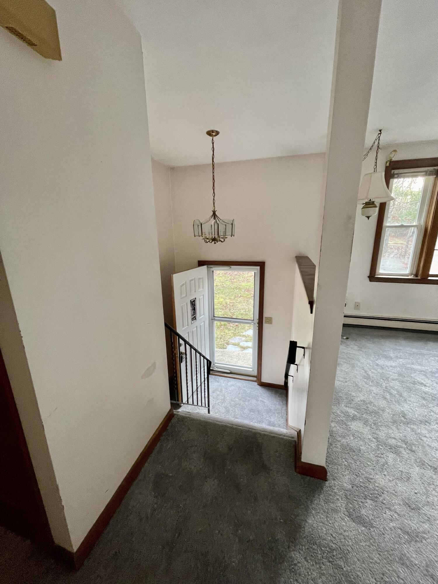 103 Clay Pond Road Bourne, MA 02532 - Photo 9 of 26 a view of a hallway with wooden floor and windows