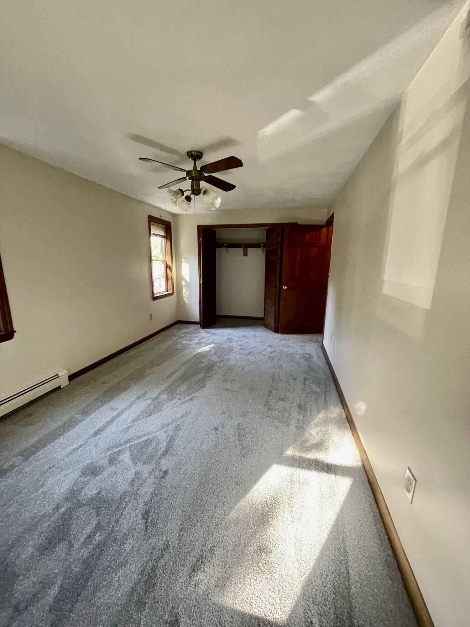 103 Clay Pond Road Bourne, MA 02532 - Photo 10 of 26 a view of a livingroom with a ceiling fan and window