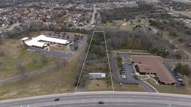 an aerial view of a residential houses with outdoor space