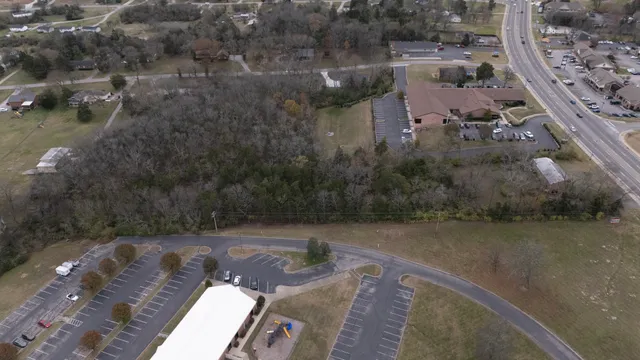 an aerial view of a house with a yard and lake view