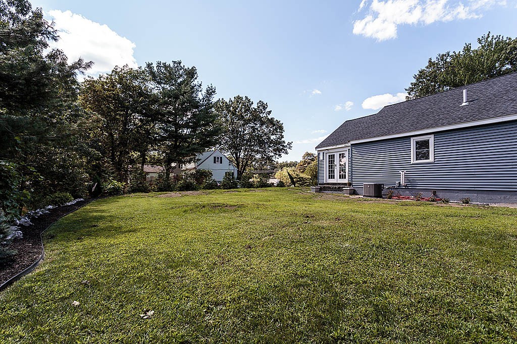 9 Arbor Road Chelmsford, MA 01863 - Photo 22 of 25 a front view of house with yard and trees