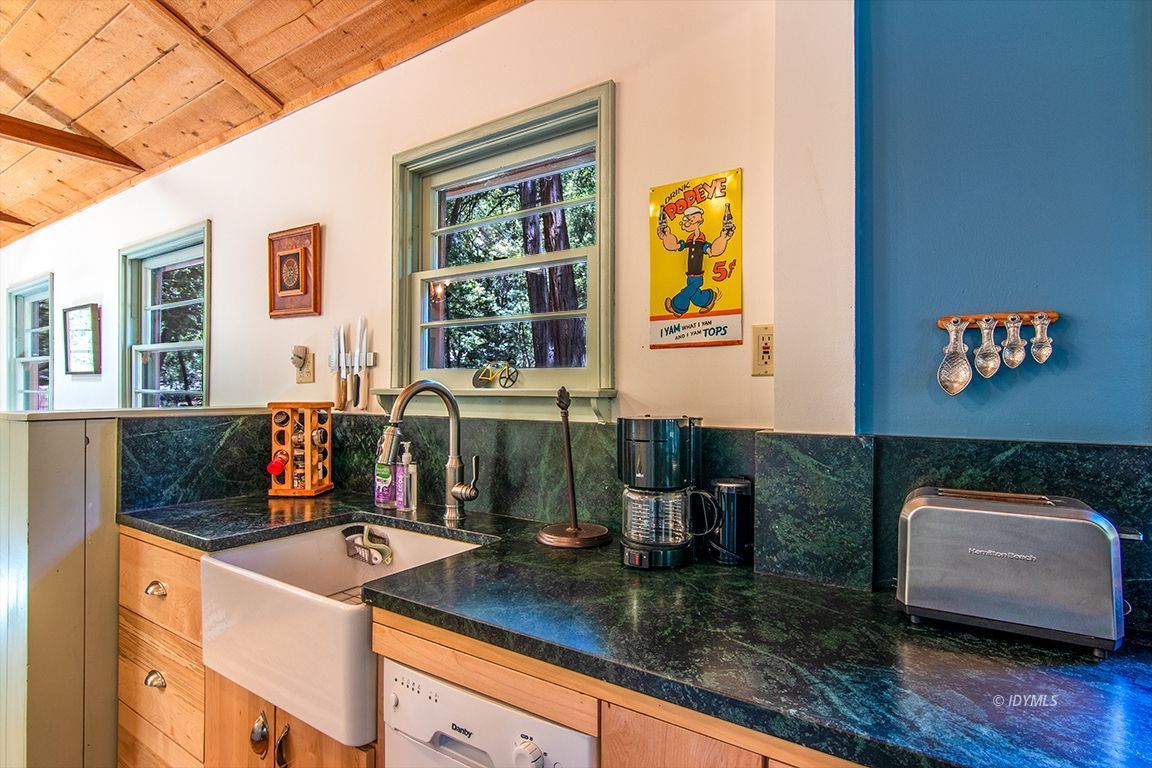 25670 Glen Road Idyllwild, CA 92549 - Photo 11 of 66 a kitchen with stainless steel appliances granite countertop a sink and a granite counter tops with a large window