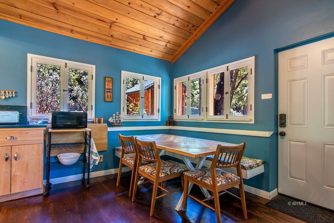 25670 Glen Road Idyllwild, CA 92549 - Photo 16 of 66 a view of a dining room with furniture window and wooden floor