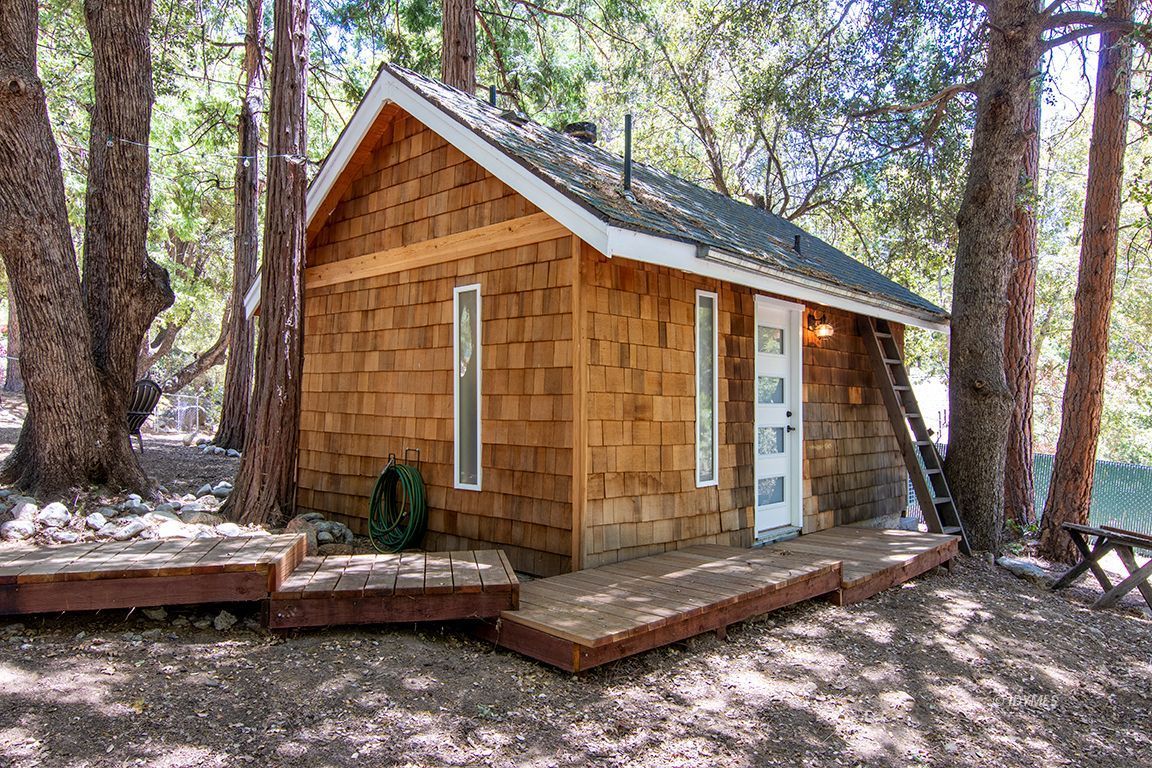 25670 Glen Road Idyllwild, CA 92549 - Photo 31 of 66 a view of backyard with large trees and wooden fence