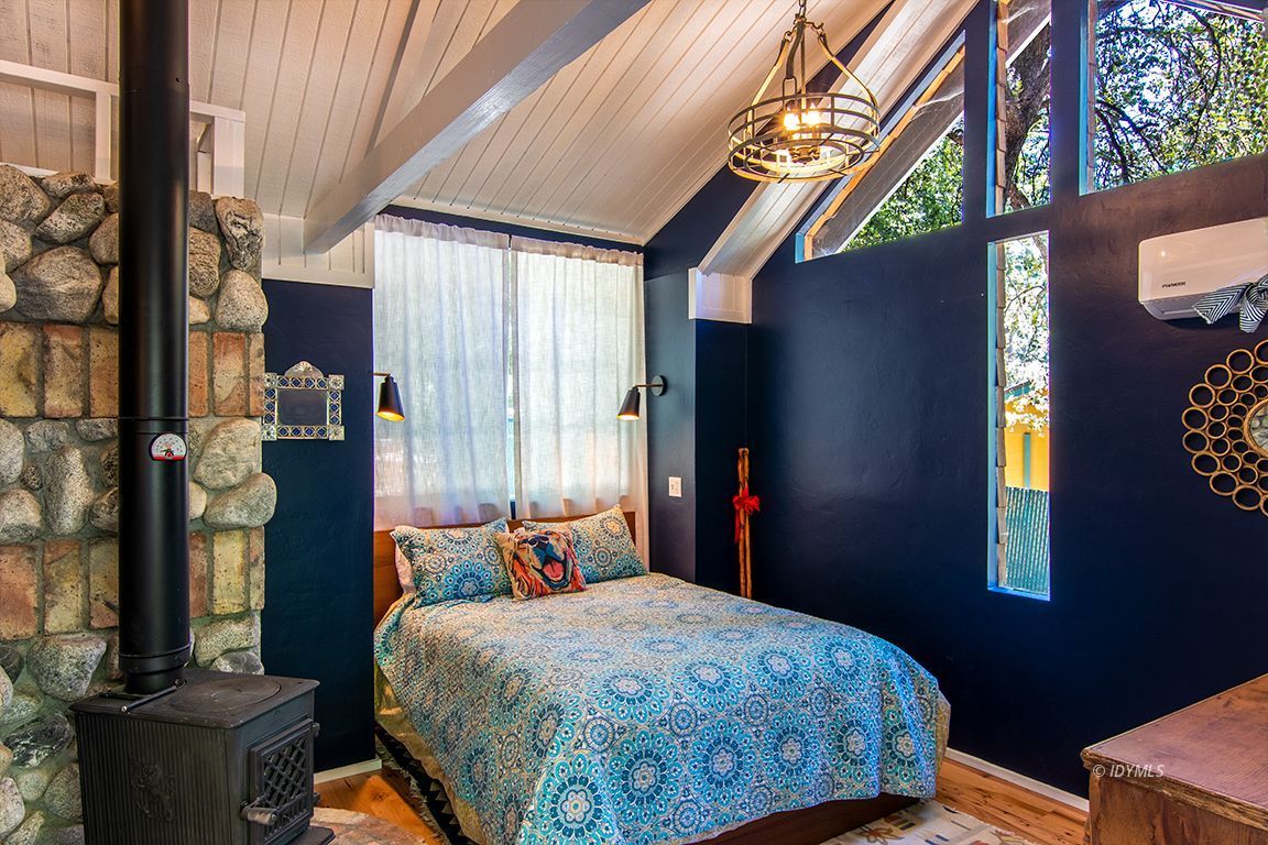 25670 Glen Road Idyllwild, CA 92549 - Photo 34 of 66 a bedroom with a bed and a window
