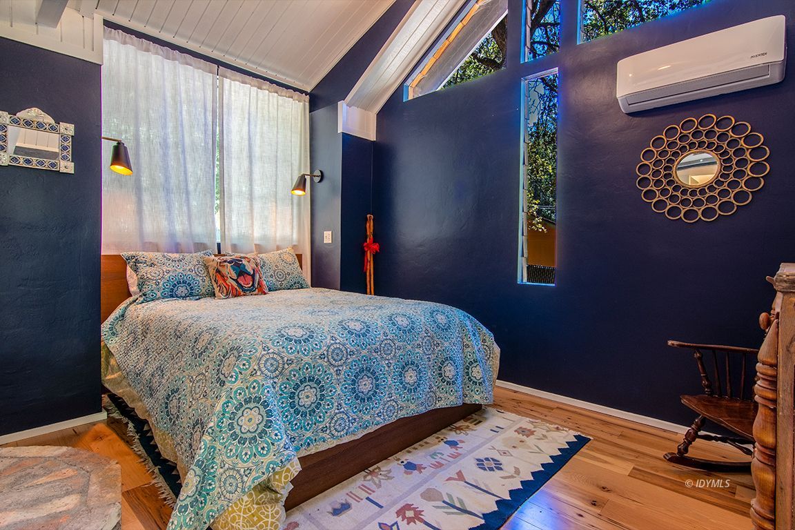 25670 Glen Road Idyllwild, CA 92549 - Photo 35 of 66 a bedroom with a bed and a lamp on dresser