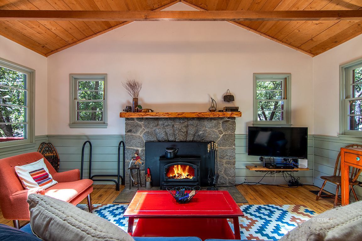 25670 Glen Road Idyllwild, CA 92549 - Photo 5 of 66 a living room with furniture a flat screen tv and a fireplace