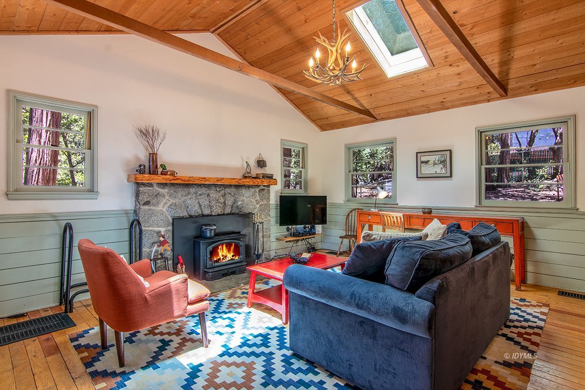 25670 Glen Road Idyllwild, CA 92549 - Photo 6 of 66 a living room with furniture a flat screen tv and a fireplace