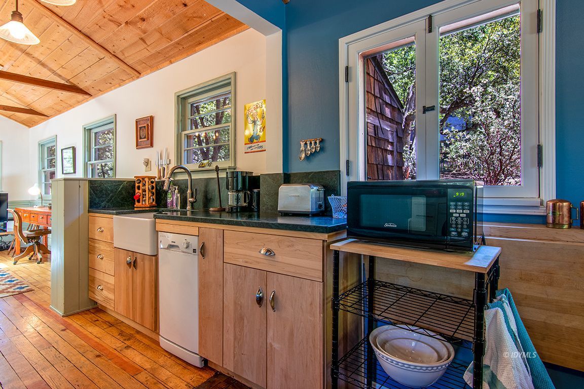 25670 Glen Road Idyllwild, CA 92549 - Photo 10 of 66 a kitchen with a table chairs refrigerator and a window