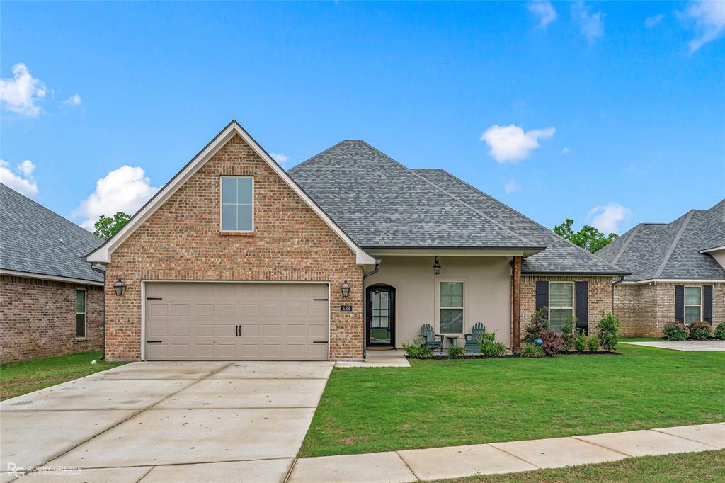 122 Brimestone Loop Benton, LA 71006 - Photo 2 of 33 a front view of a house with a garden