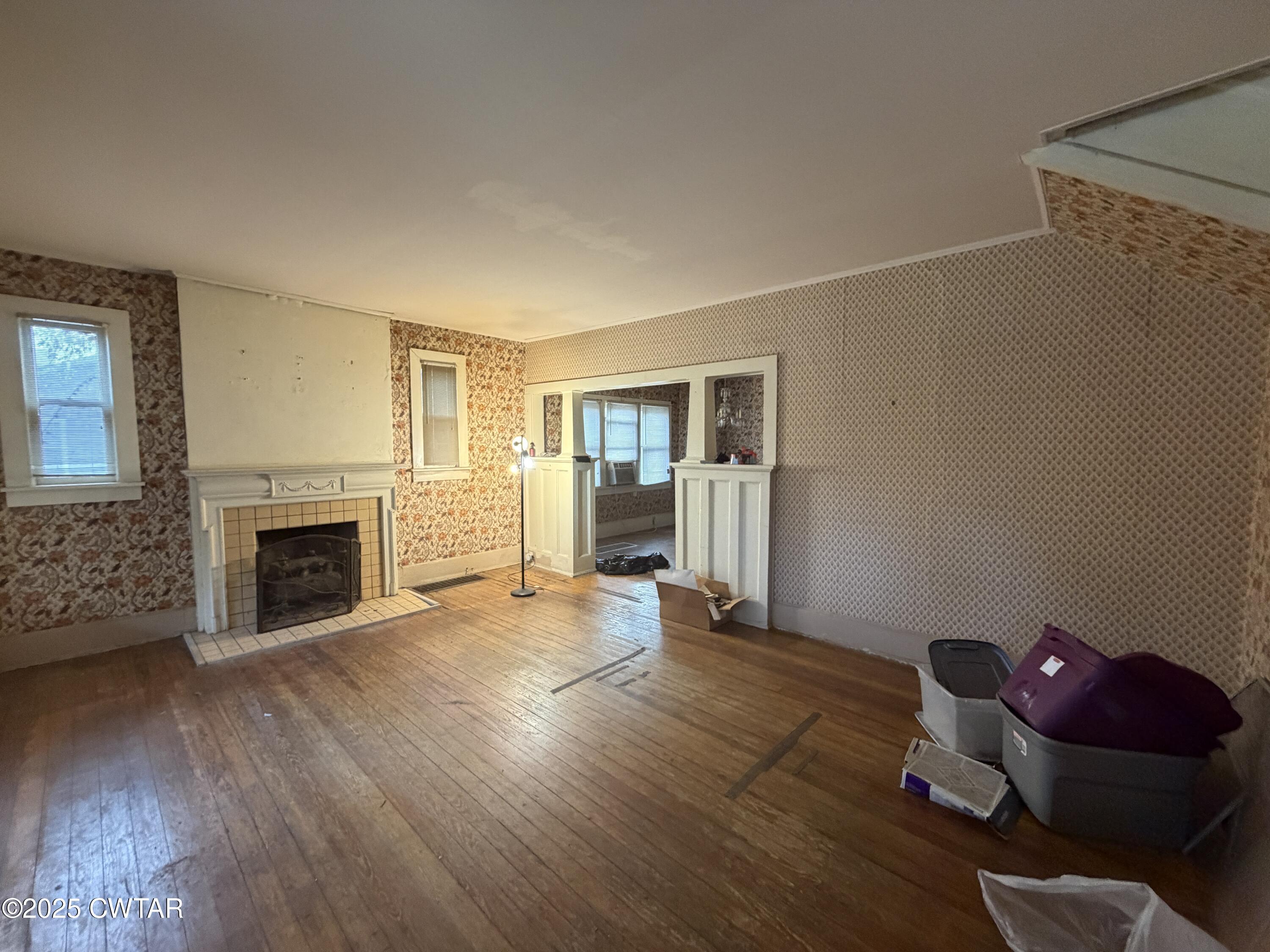 400 West Grand Street Jackson, TN 38301 - Photo 3 of 13 a view of a livingroom with wooden floor and a fireplace