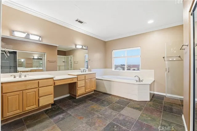 a large bathroom with a double vanity sink a mirror and a bathtub