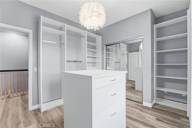 a kitchen with white cabinets and chandelier
