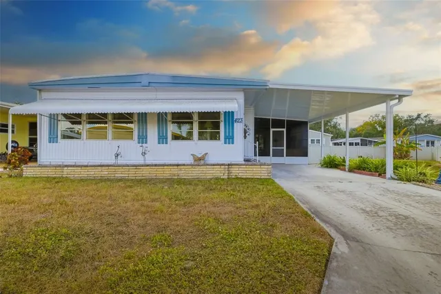 a view of an house with backyard and porch
