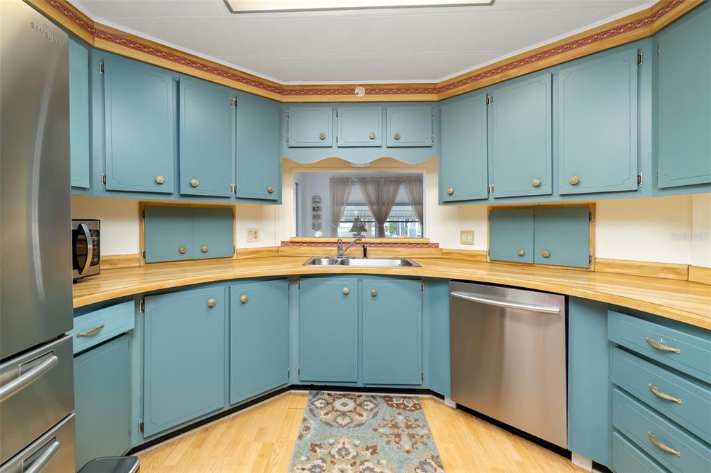 5619 Bayshore Road, Unit 423 Palmetto, FL 34221 - Photo 14 of 55 a kitchen with a sink cabinets and wooden floor
