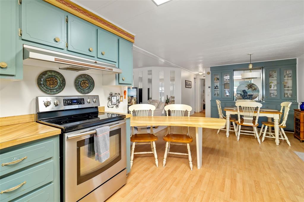 5619 Bayshore Road, Unit 423 Palmetto, FL 34221 - Photo 15 of 55 a kitchen with a stove and chairs