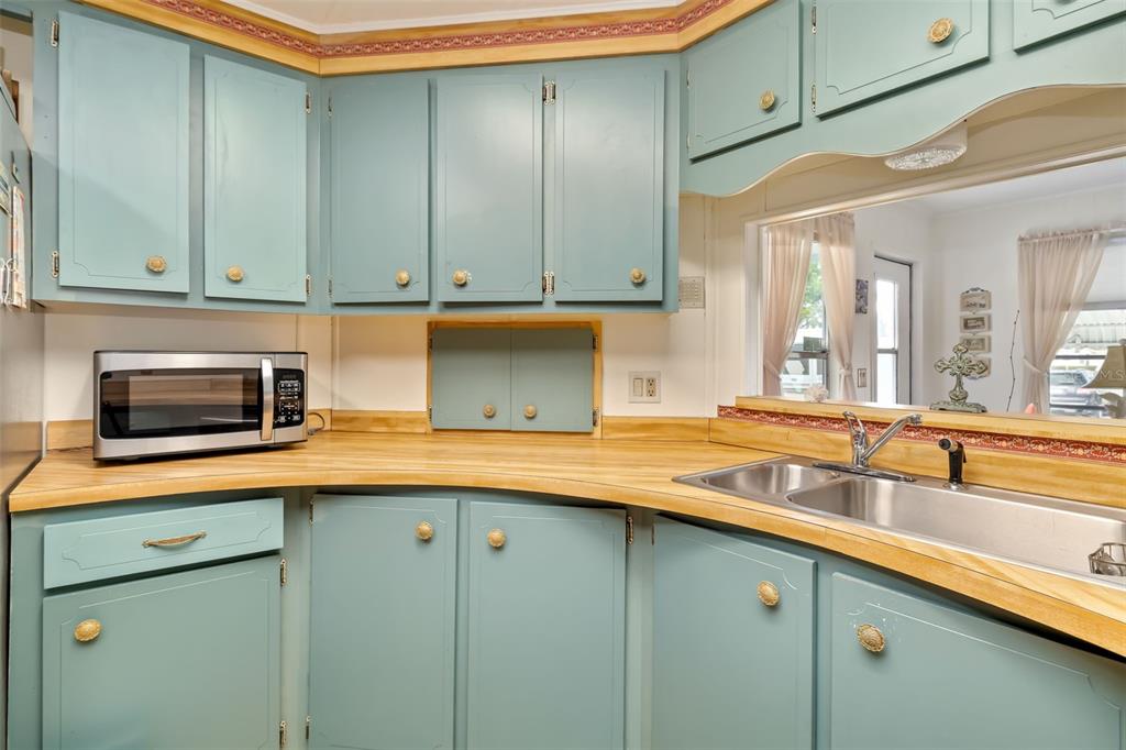 5619 Bayshore Road, Unit 423 Palmetto, FL 34221 - Photo 16 of 55 a kitchen with stainless steel appliances granite countertop a sink and a microwave