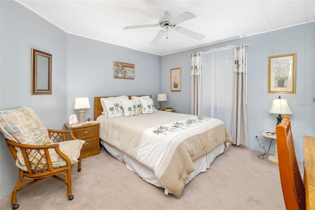 5619 Bayshore Road, Unit 423 Palmetto, FL 34221 - Photo 18 of 55 a spacious bedroom with a bed and chair
