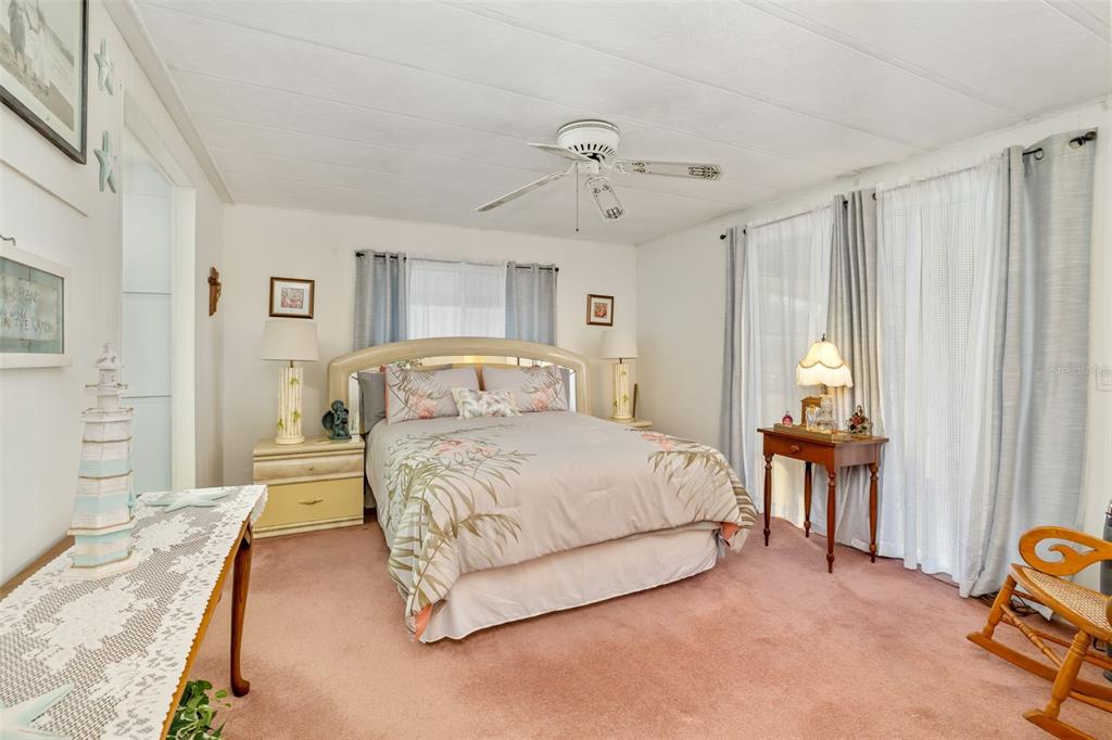 5619 Bayshore Road, Unit 423 Palmetto, FL 34221 - Photo 21 of 55 a bedroom with a bed and a chandelier