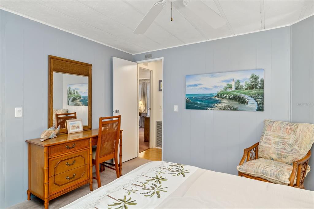 5619 Bayshore Road, Unit 423 Palmetto, FL 34221 - Photo 22 of 55 a bedroom with a bed and wooden floor