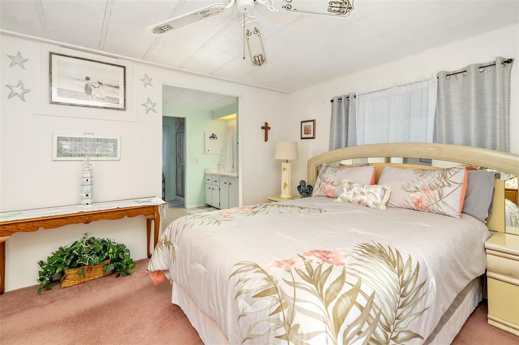 5619 Bayshore Road, Unit 423 Palmetto, FL 34221 - Photo 23 of 55 a bedroom with a bed and a potted plant