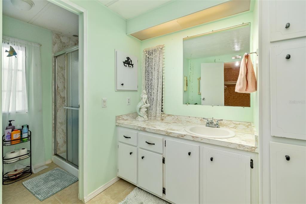 5619 Bayshore Road, Unit 423 Palmetto, FL 34221 - Photo 25 of 55 a bathroom with a granite countertop sink and a mirror