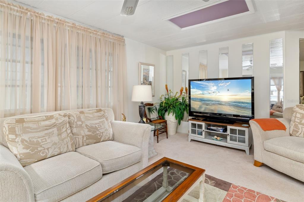 5619 Bayshore Road, Unit 423 Palmetto, FL 34221 - Photo 4 of 55 a living room with furniture and a flat screen tv