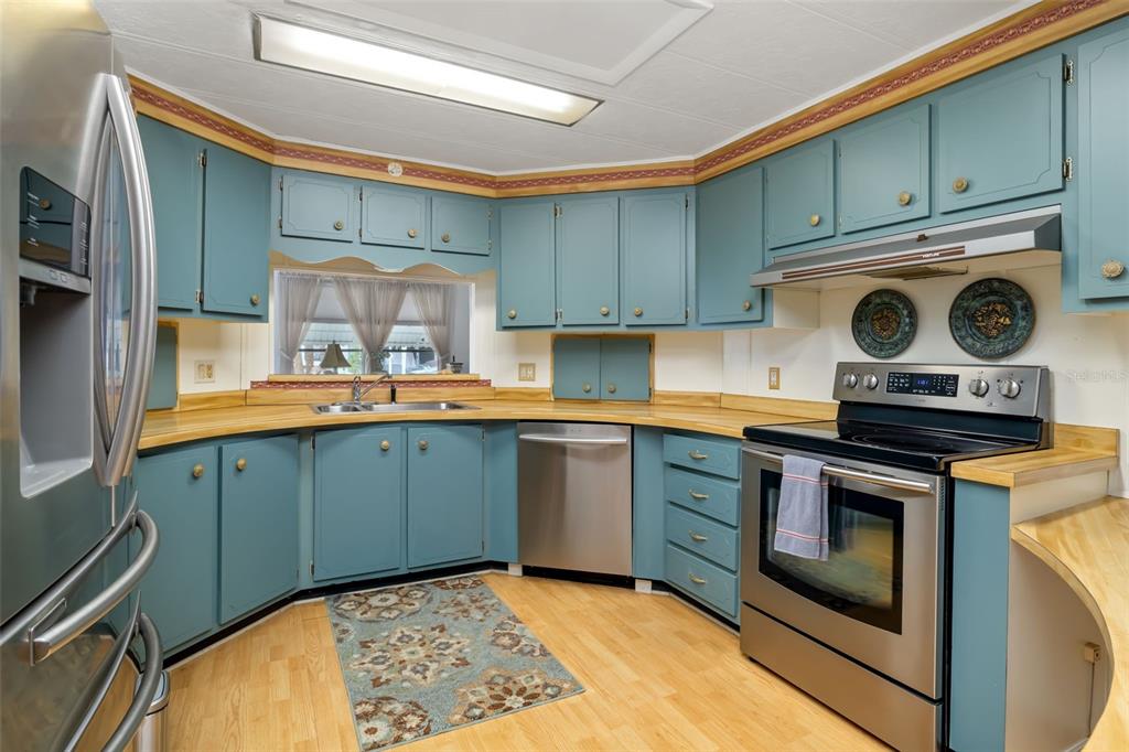 5619 Bayshore Road, Unit 423 Palmetto, FL 34221 - Photo 5 of 55 a kitchen with stainless steel appliances granite countertop a sink stove and cabinets