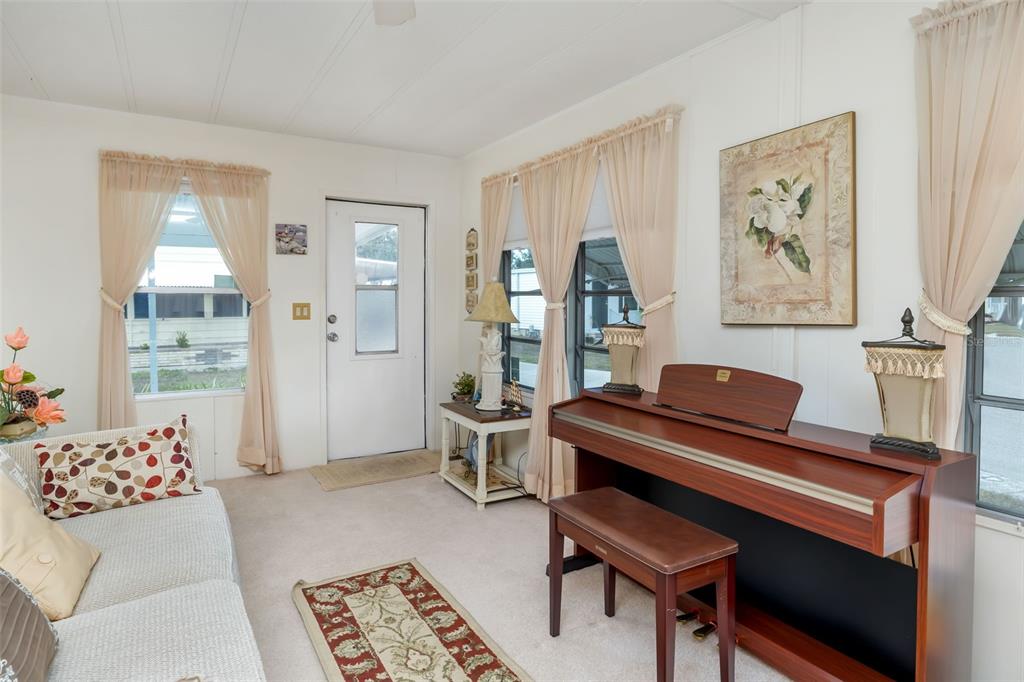 5619 Bayshore Road, Unit 423 Palmetto, FL 34221 - Photo 6 of 55 a living room with furniture and a piano