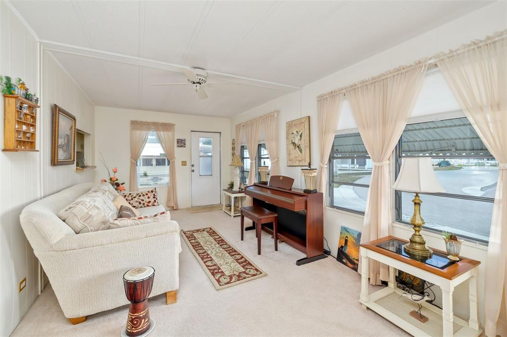 5619 Bayshore Road, Unit 423 Palmetto, FL 34221 - Photo 8 of 55 a living room with furniture a flat screen tv and a window