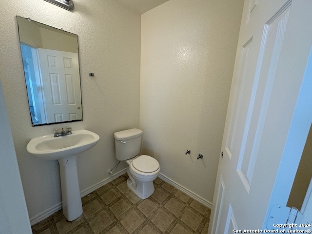 4622 Rothberger Way San Antonio, TX 78244 - Photo 12 of 23 a bathroom with a sink toilet and a mirror