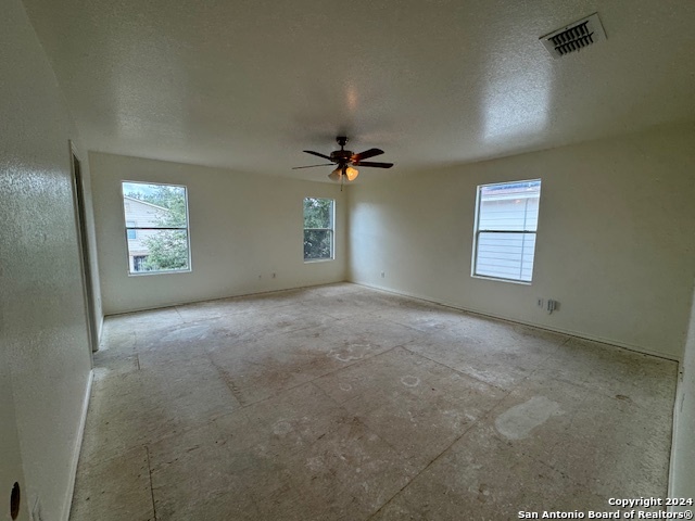 4622 Rothberger Way San Antonio, TX 78244 - Photo 15 of 23 an empty room with windows and ceiling fan