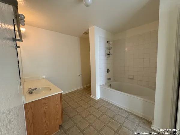 a bathroom with a bathtub and shower