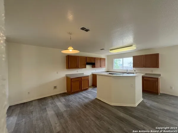 a kitchen with stainless steel appliances a stove top oven a sink dishwasher and a refrigerator