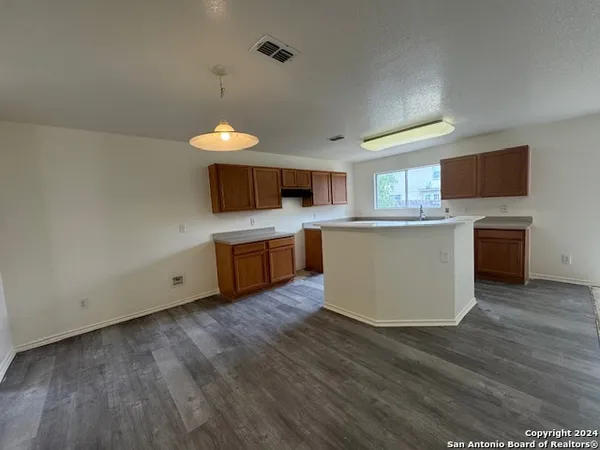 a kitchen with a sink and wooden cabinets