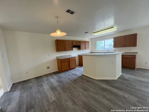 a kitchen with a stove a sink and a microwave
