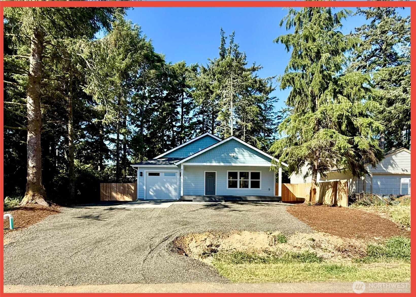 611 Weatherwax Loop Northeast Ocean Shores, WA 98569 - Photo 18 of 39 a front view of a house with a yard covered in snow
