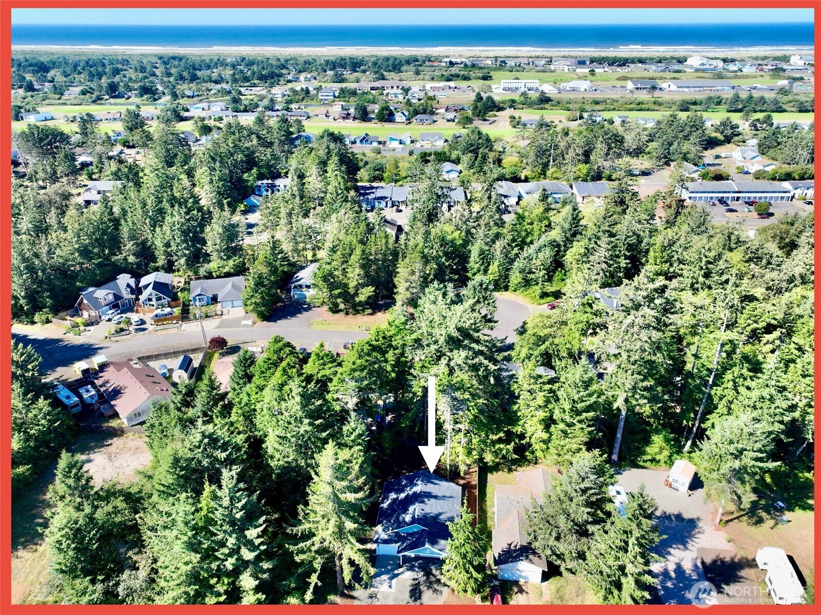 611 Weatherwax Loop Northeast Ocean Shores, WA 98569 - Photo 2 of 39 an aerial view of a houses with a yard