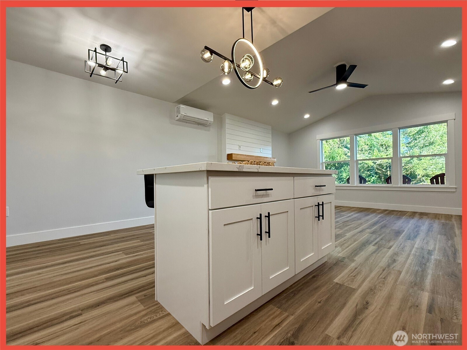 611 Weatherwax Loop Northeast Ocean Shores, WA 98569 - Photo 24 of 39 a kitchen with a white cabinets and chandelier