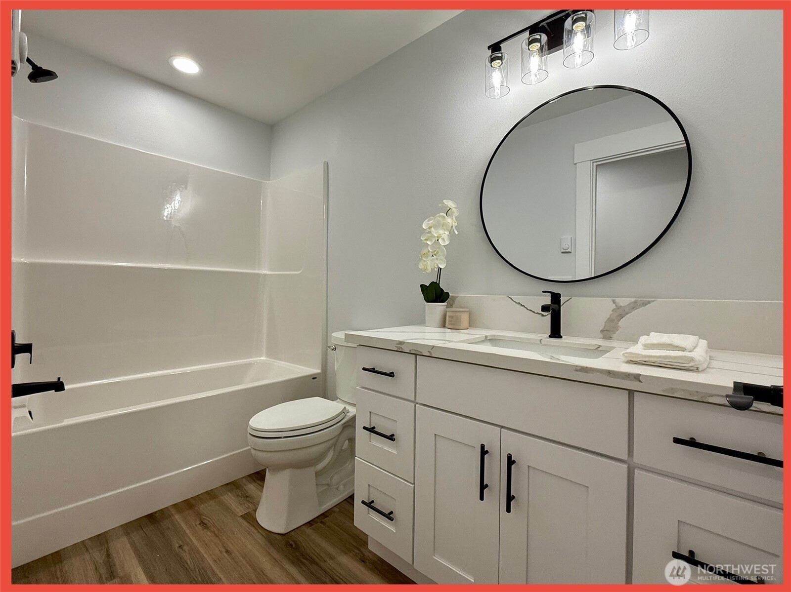 611 Weatherwax Loop Northeast Ocean Shores, WA 98569 - Photo 29 of 39 a bathroom with a toilet a sink and a mirror