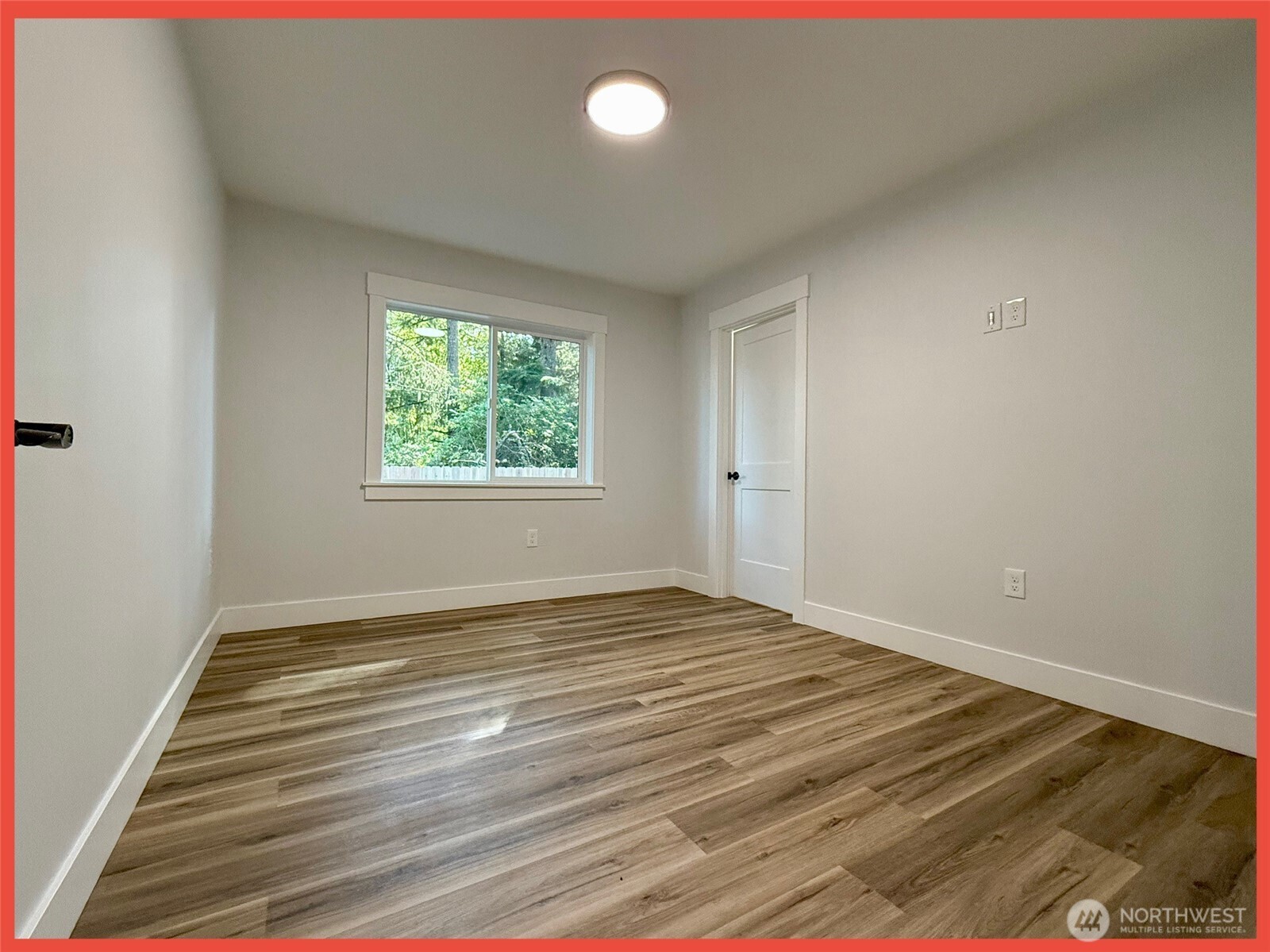 611 Weatherwax Loop Northeast Ocean Shores, WA 98569 - Photo 30 of 39 an empty room with wooden floor and windows