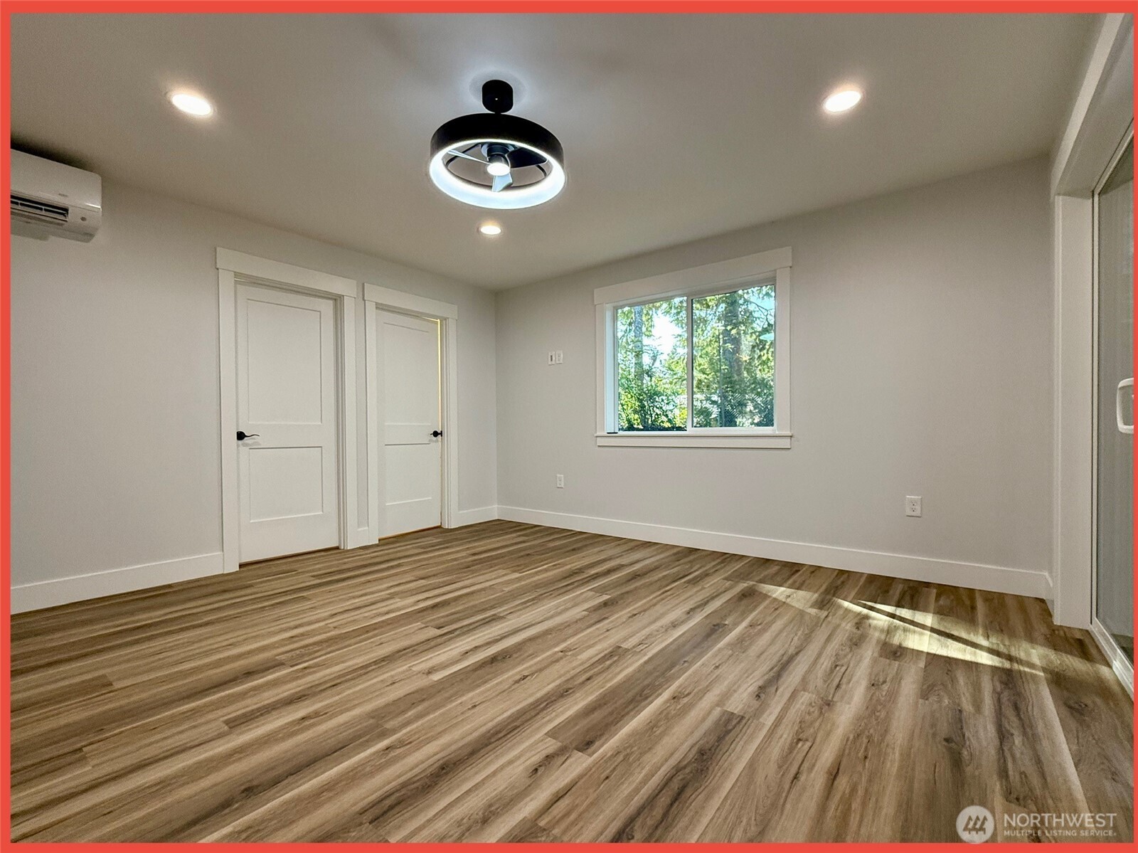 611 Weatherwax Loop Northeast Ocean Shores, WA 98569 - Photo 35 of 39 a view of an empty room with window and wooden floor